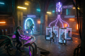 Alien technician monitors a portal beside humans in illuminated laboratory pods