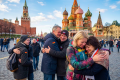 Friends embracing in Moscow’s Red Square beneath Saint Basil’s Cathedral